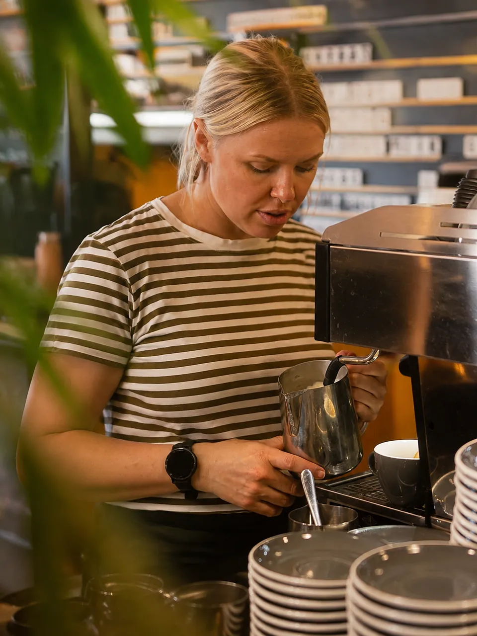 A Suburban Rascal barista steaming milk at the espresso machine