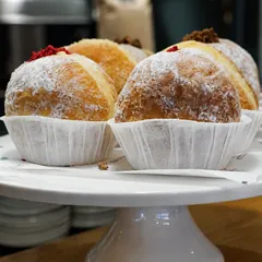 Sugar-dusted sweet treats displayed on a cake stand at Suburban Rascal