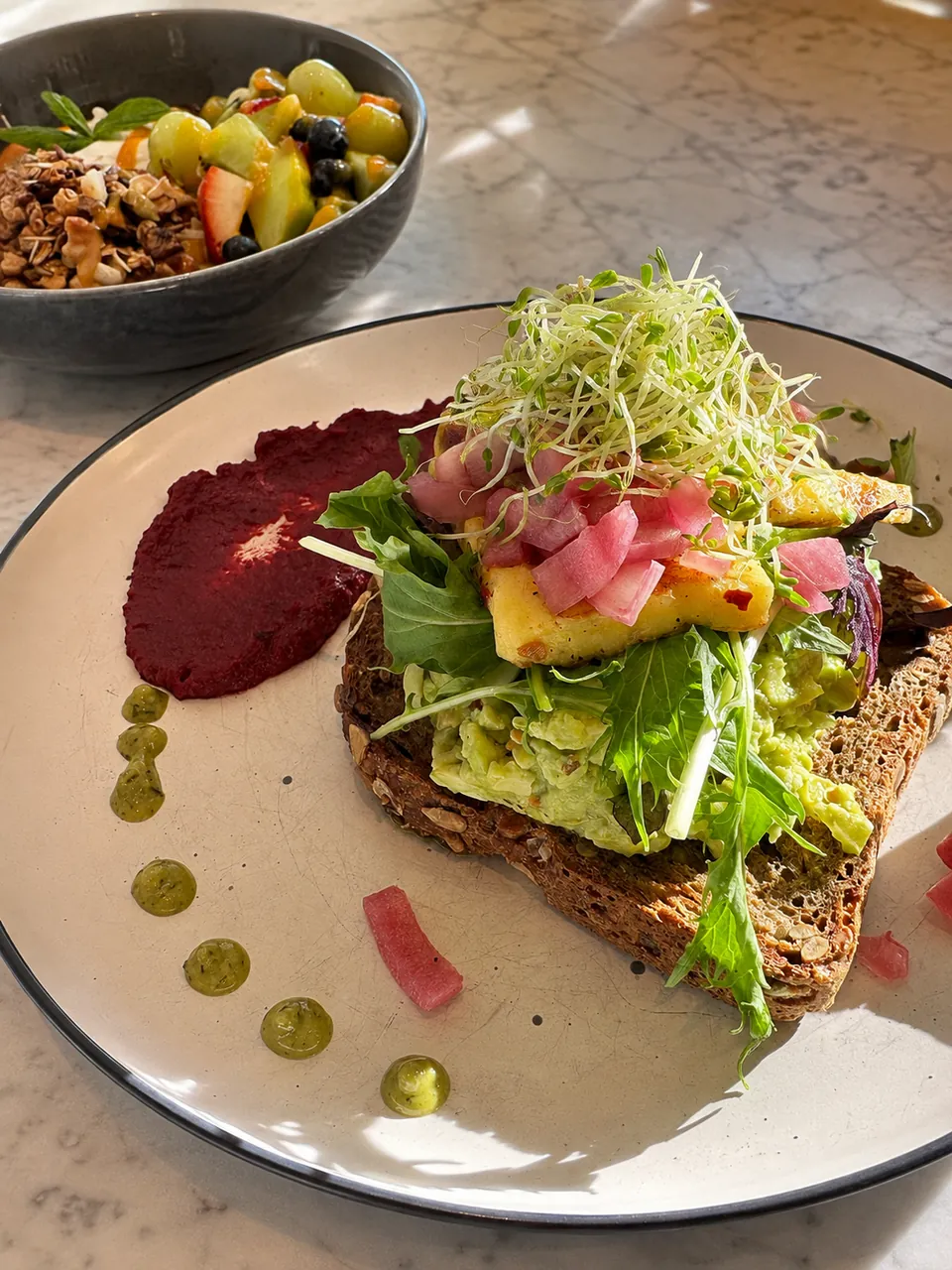 Avocado toast with crisp greens and pickled vegetables