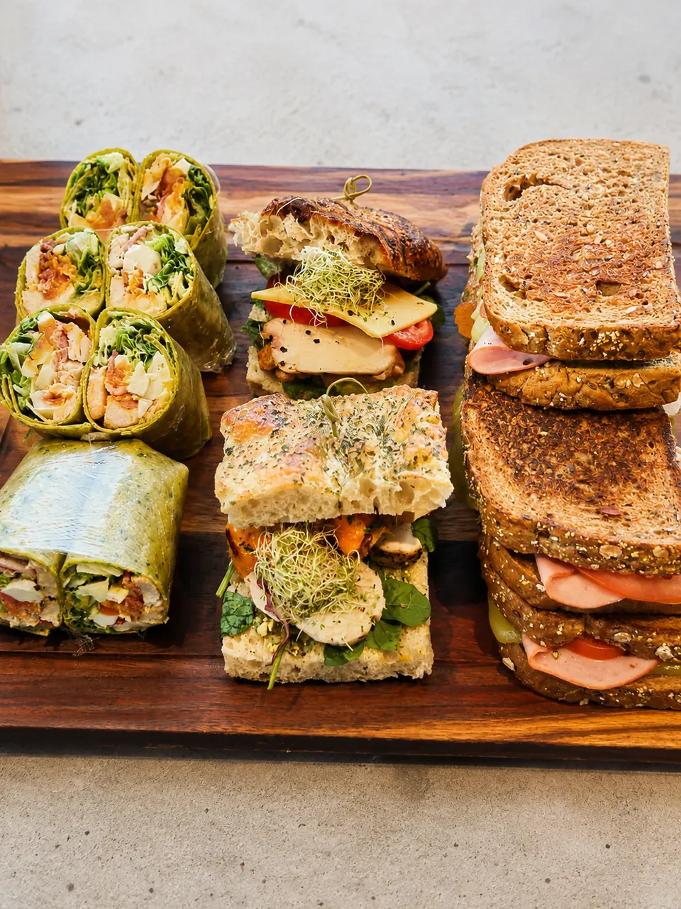 Fresh wraps and stacked sandwiches ready to share