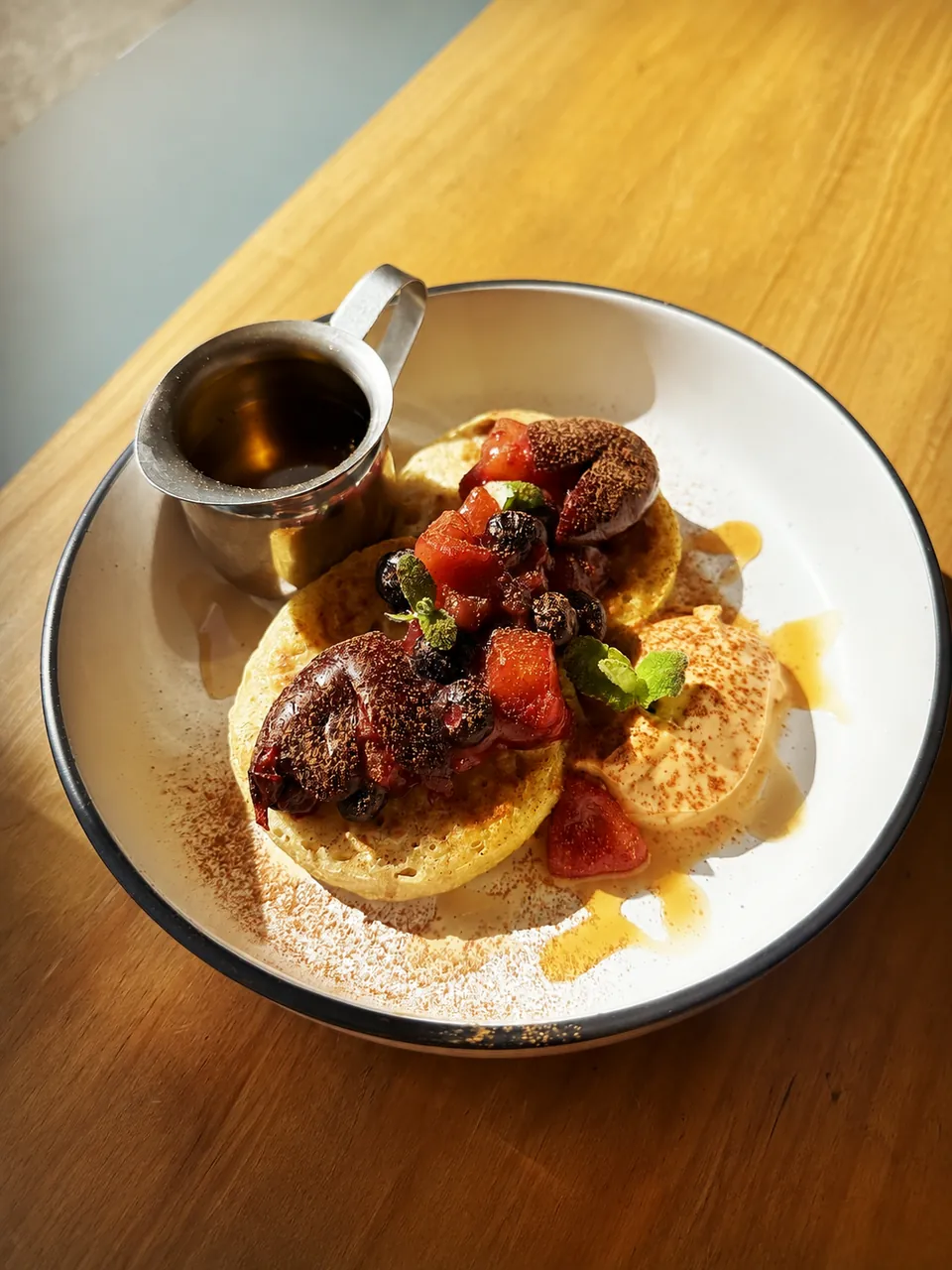 Pancakes with stewed fruit, ice cream and maple syrup