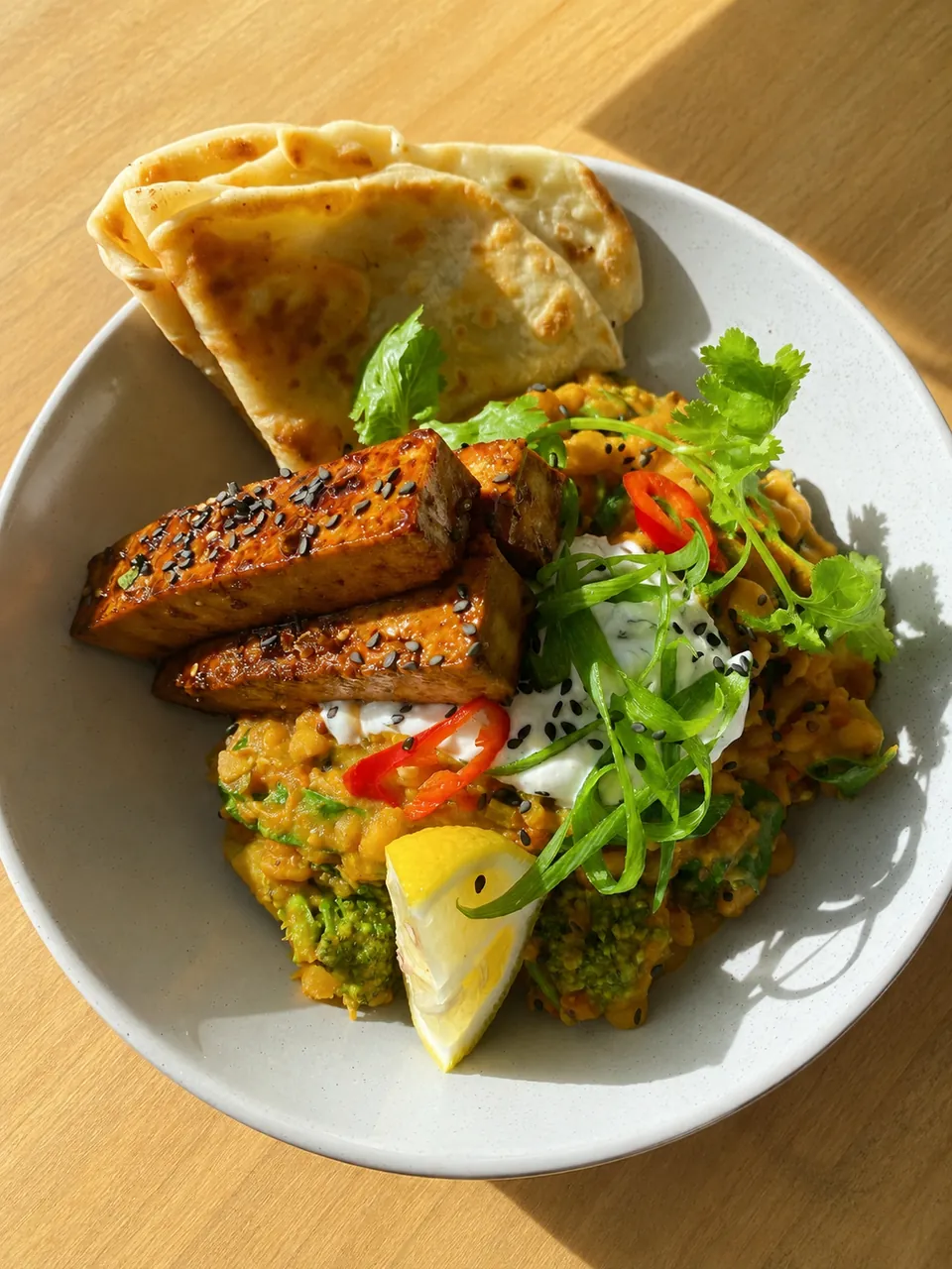 Golden tofu with vegetables, flatbread and fresh herbs